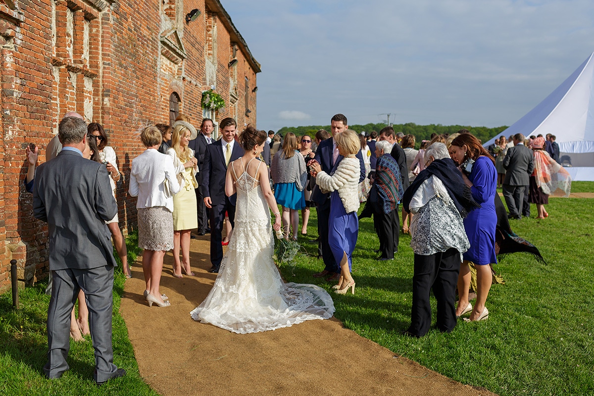 the bride talks to her guests outside