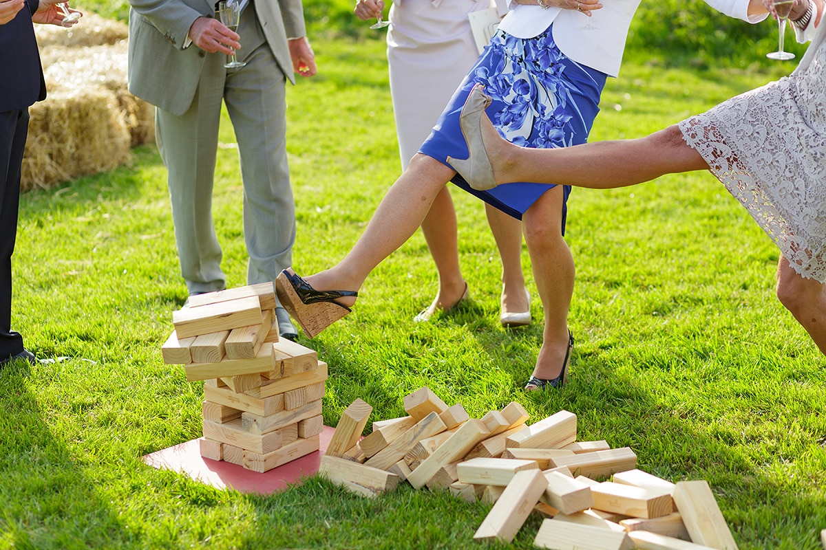 a guest kicks over the jenga pile outside godwick barn