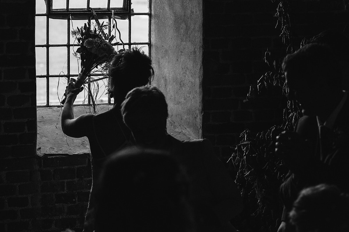 the bride places her bouquet on the windowsill