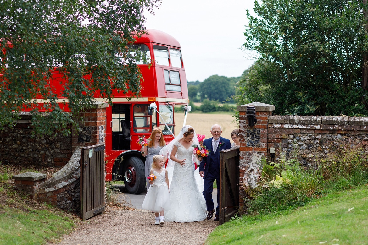 the brides father steps on her dress in front of the routemaster bus