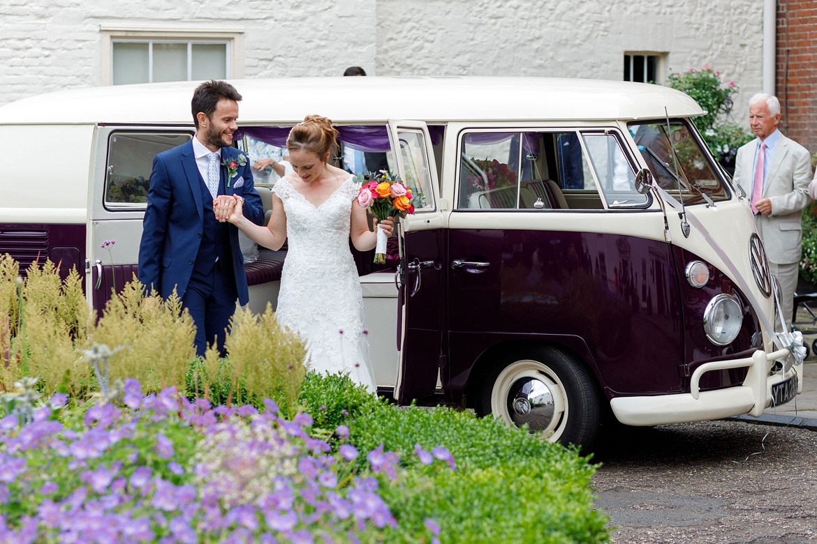 kate and daniel leave their campervan wedding car