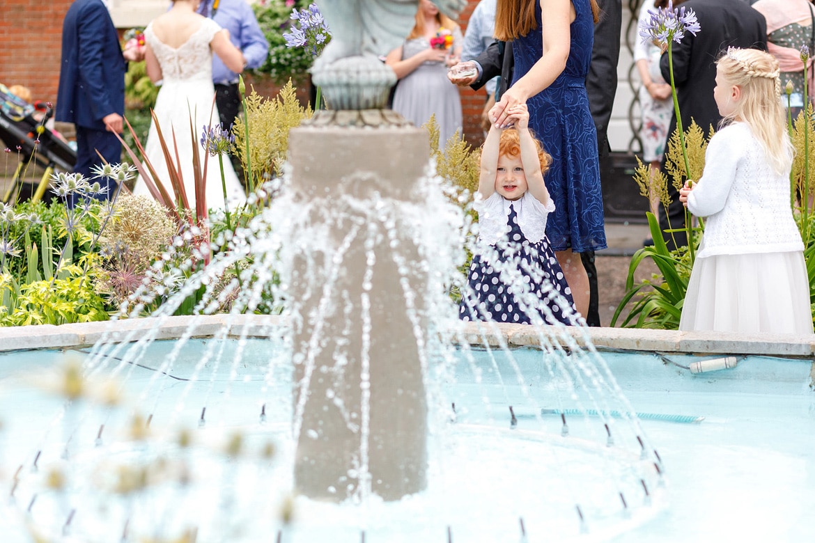 a child plays in the fountain