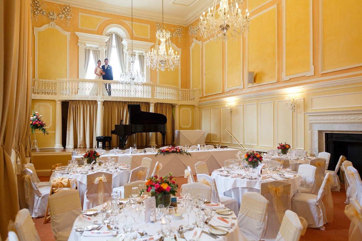 bride and groom on the balcony of the assembly house music room