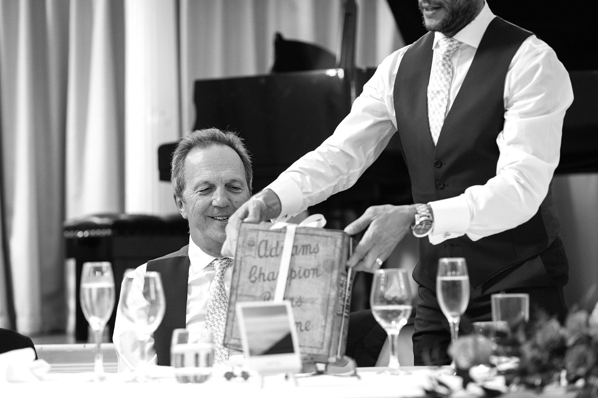 the groom presents his dad with a present