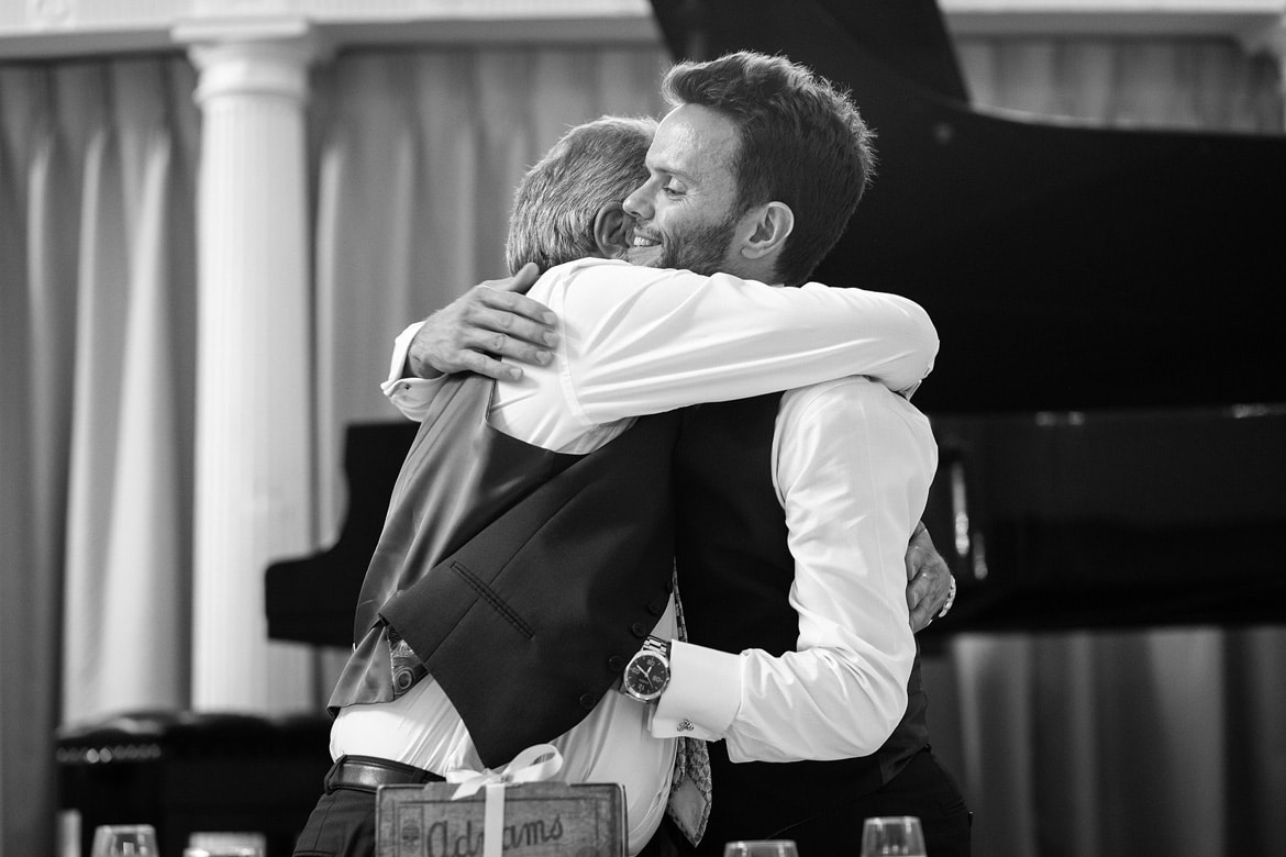 groom and dad hug