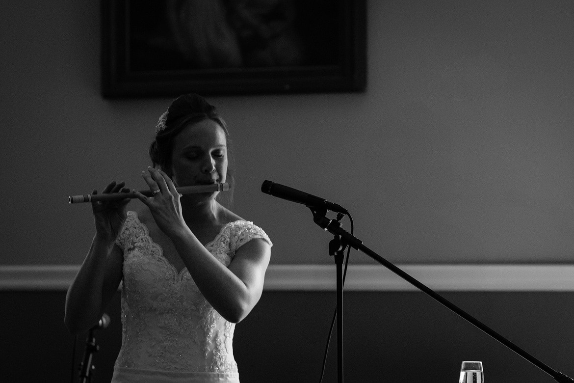 kate plays a wooden flute during her assembly house wedding