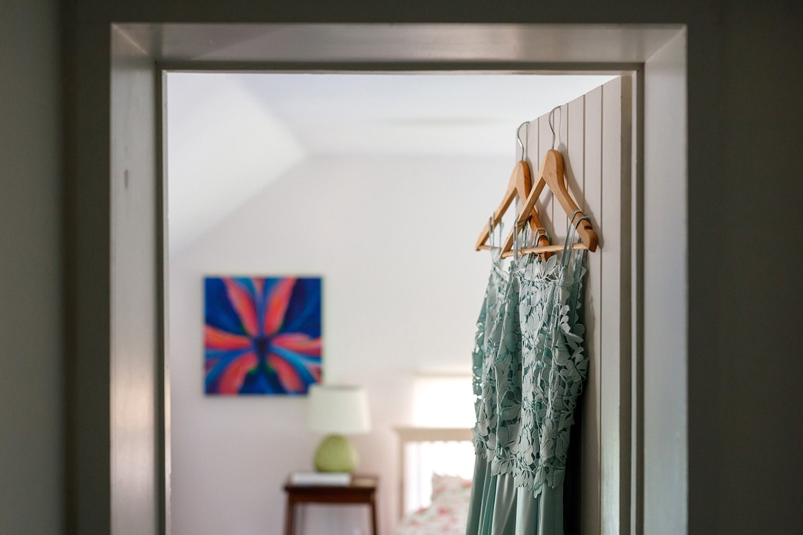 bridesmaid dresses hanging in a doorway