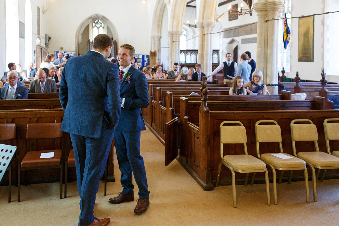 the groom and best man inside the church