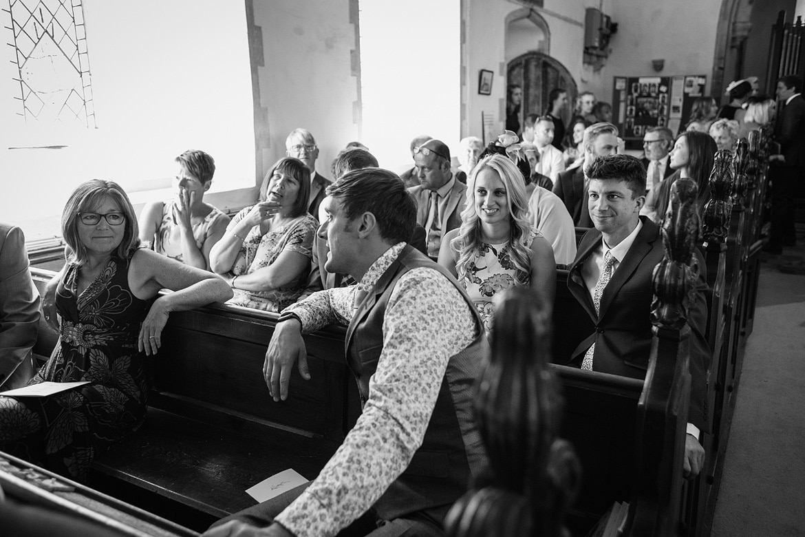 guests at a wedding at old buckenham church