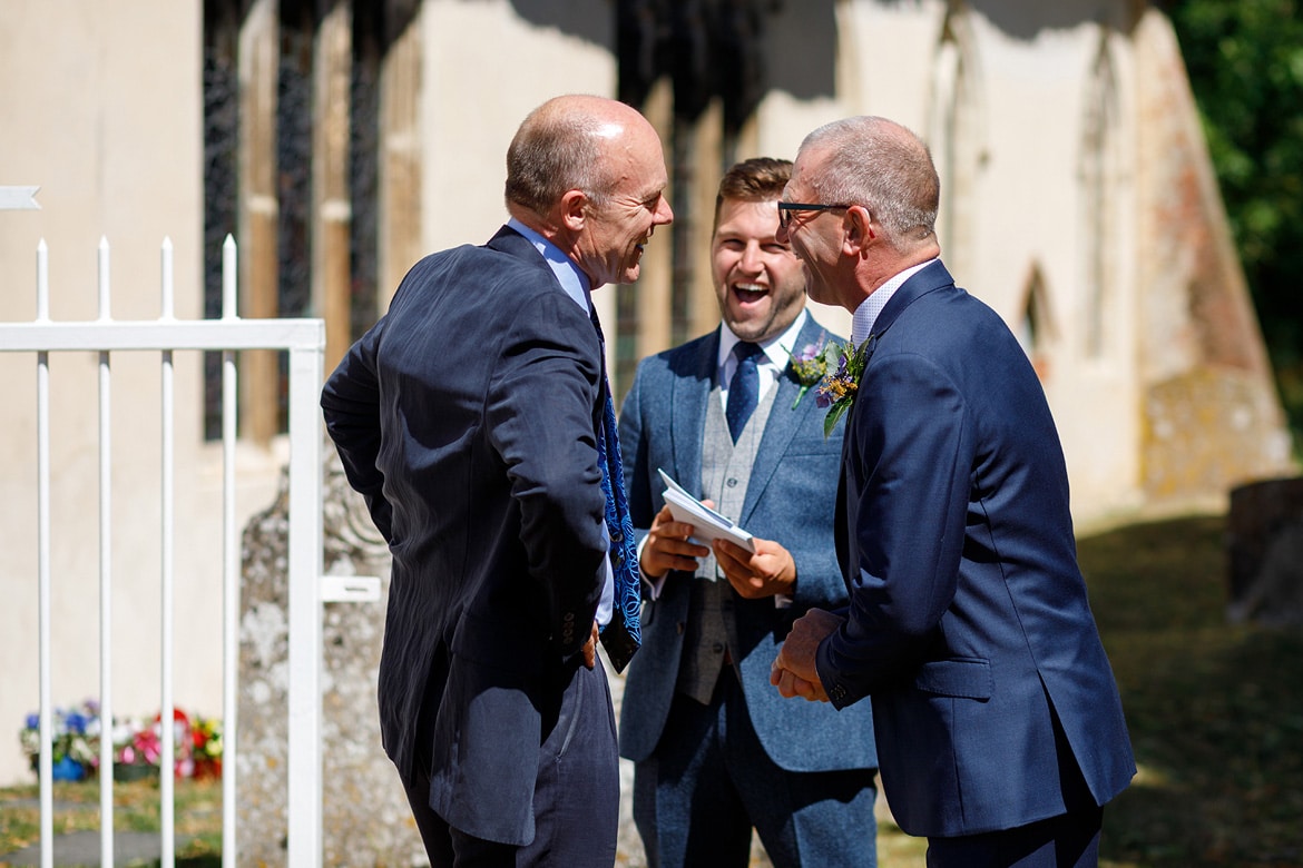 the grooms father and ushers laugh