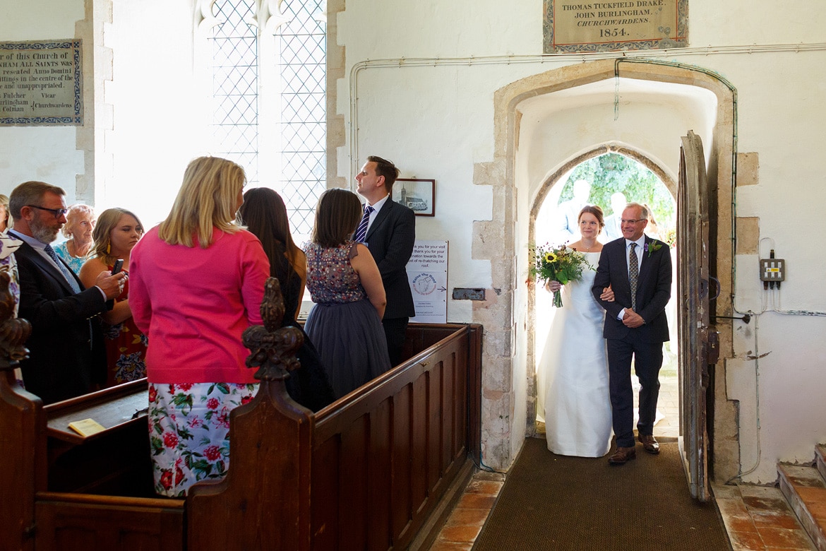 the bride and her father enter the church