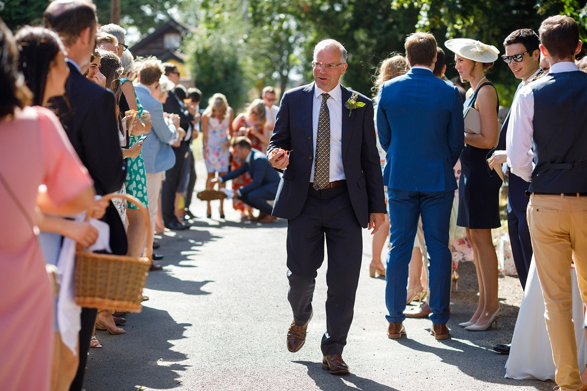 the brides father with confetti