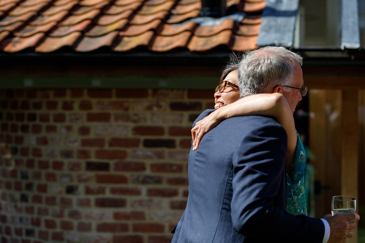 the brides father greets a guest