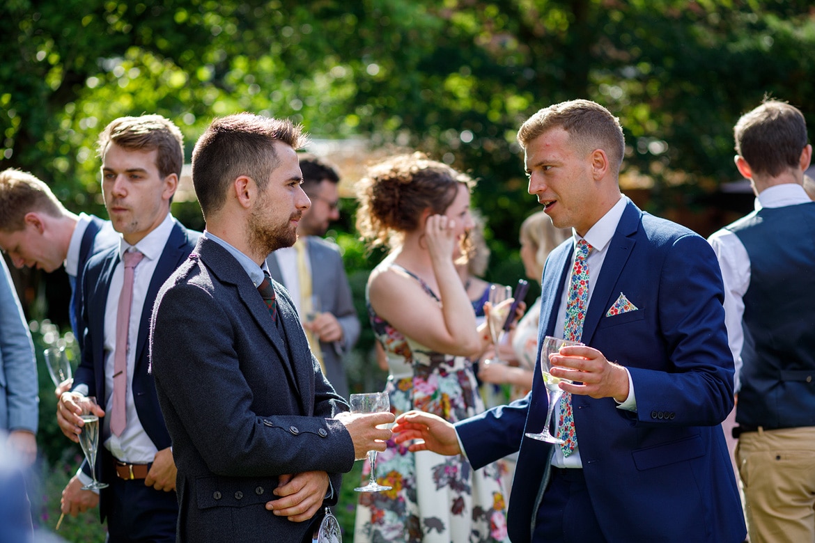 wedding guests talking in the garden