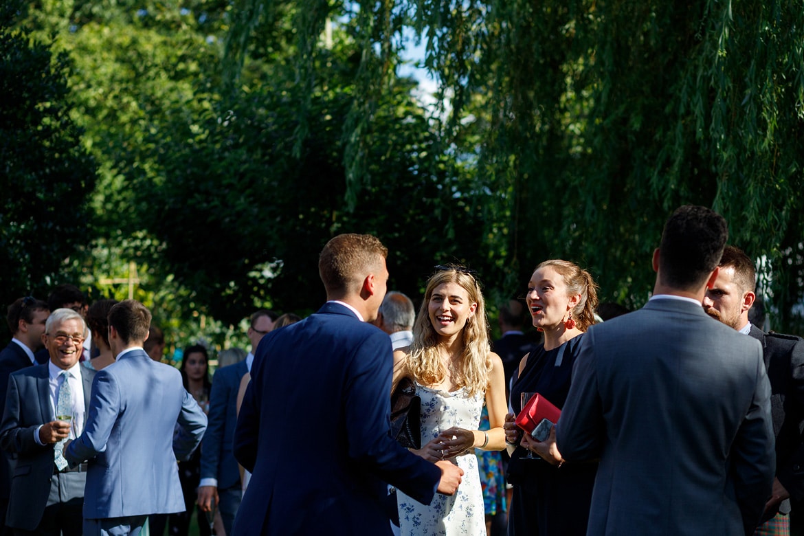 wedding guests talking in the garden