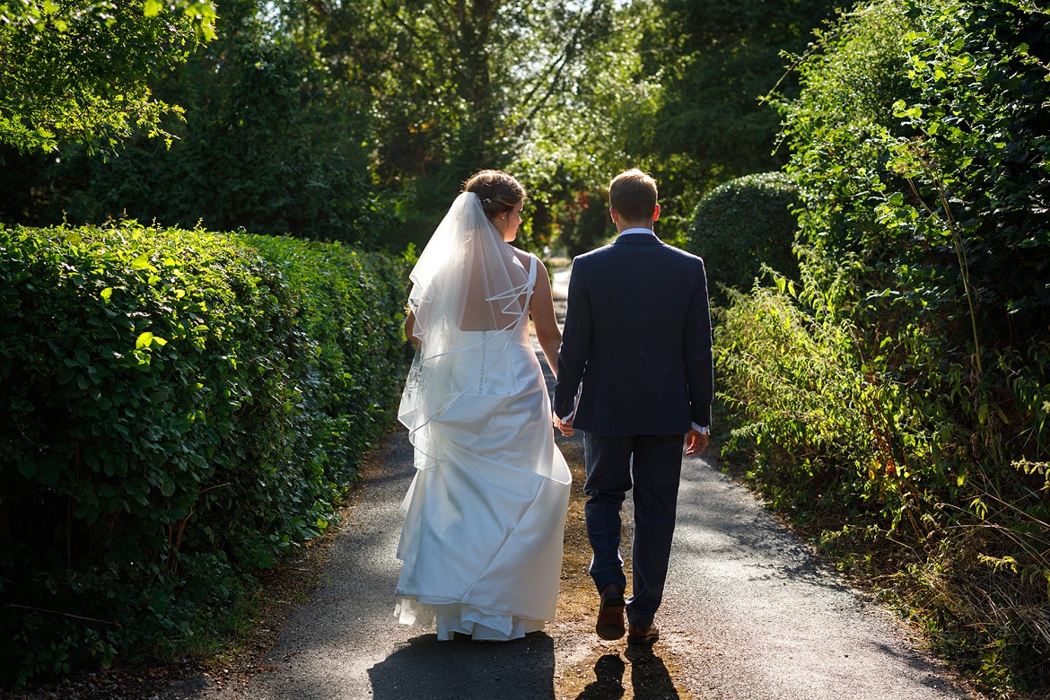 bride and groom walking in the lane 