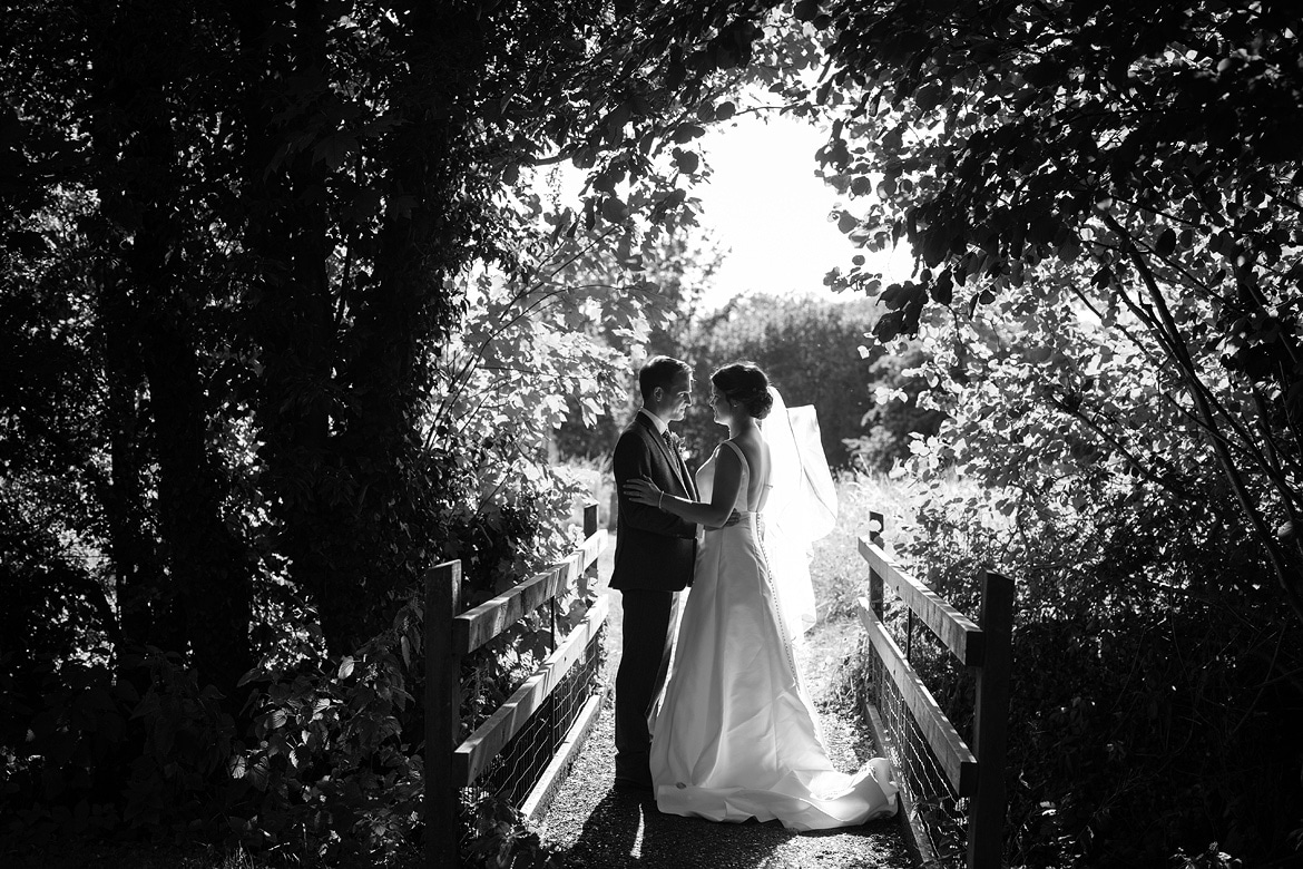 bride and groom in the grounds of old buckenham church