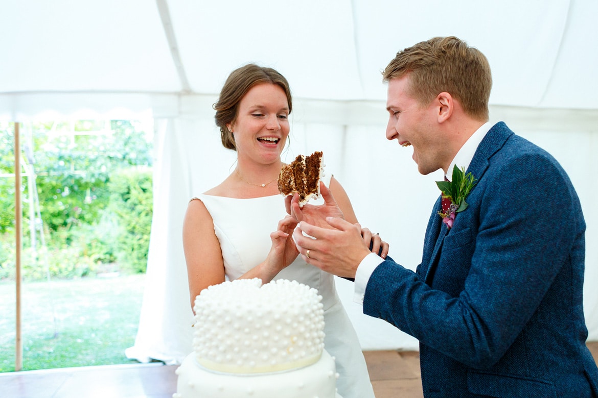 bride and groom cut the cake