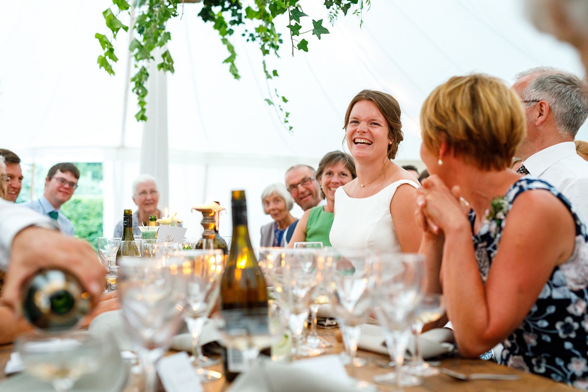 the bride laughs at the grooms speech