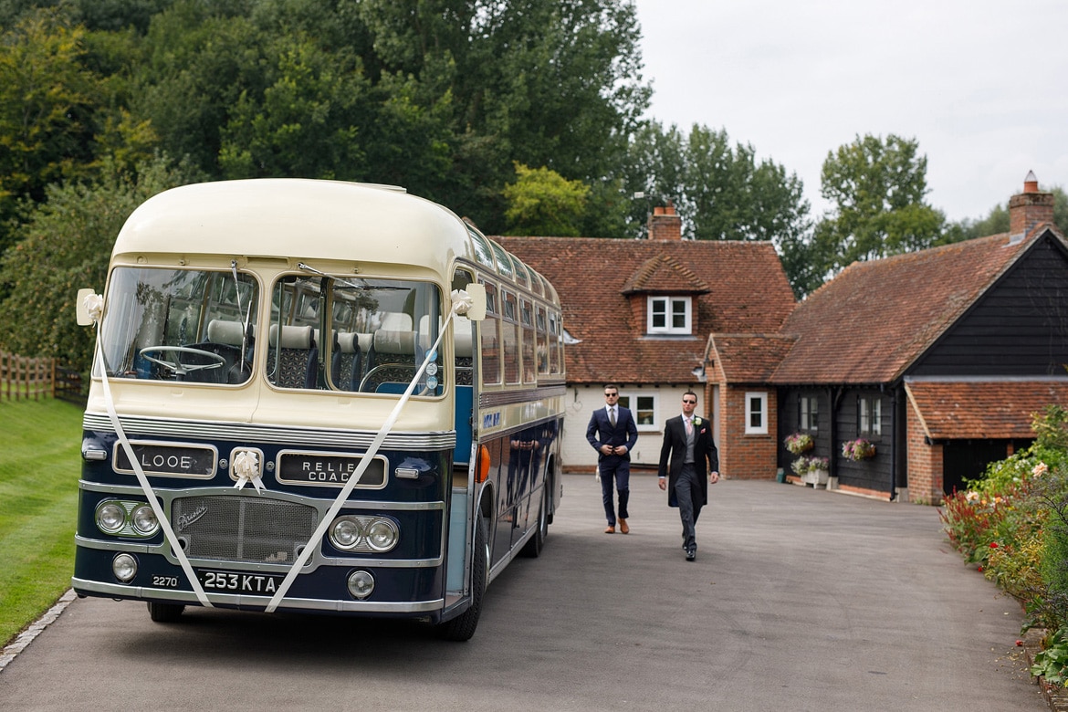 with the vintage wedding bus outside the brides home