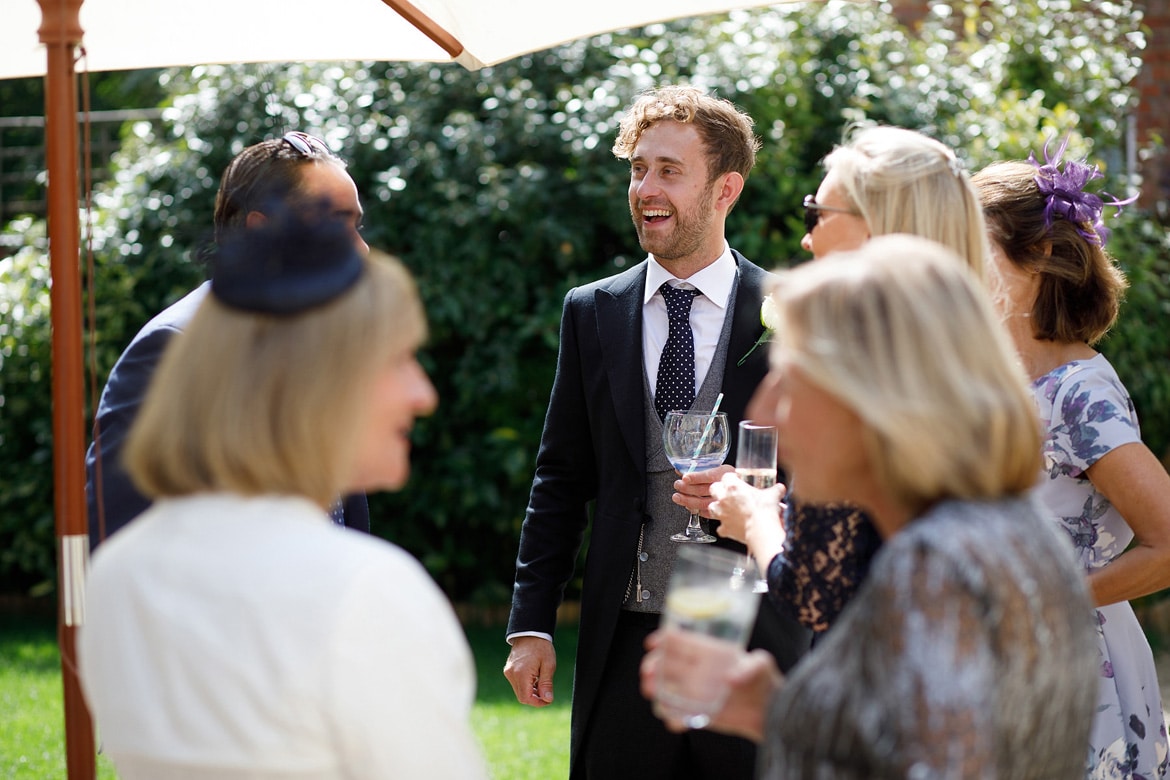 the groom laughing with the guests