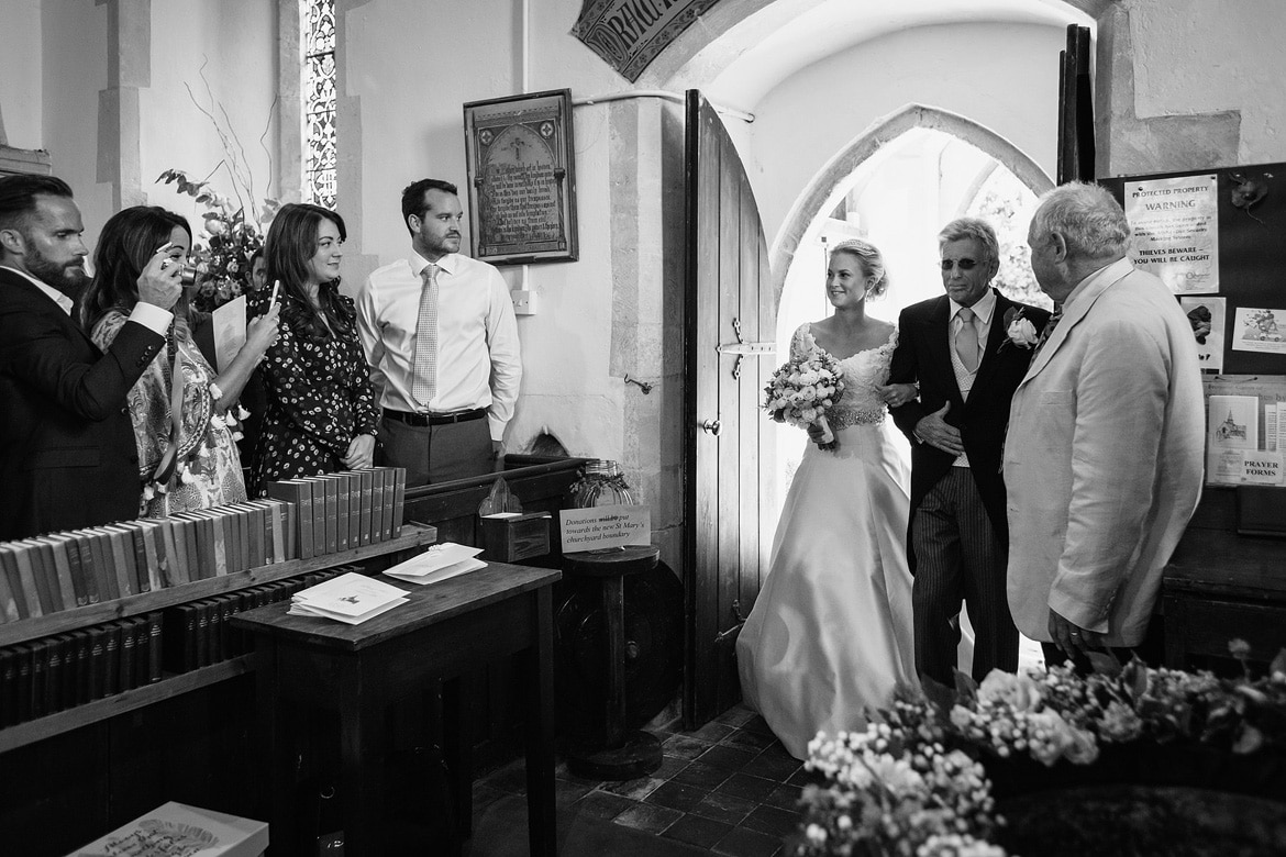 bride and father enter the church