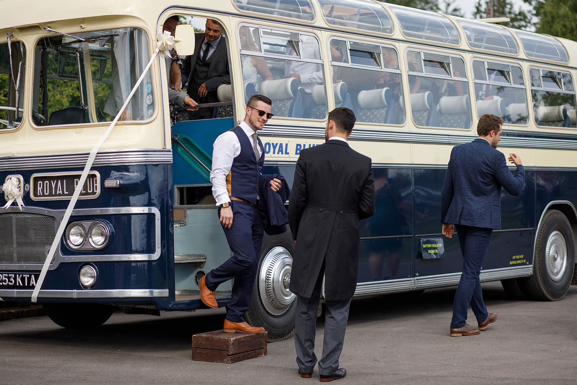 guests leaving the vintage wedding bus