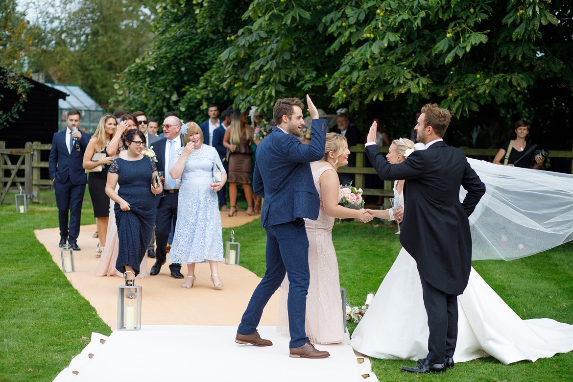 bride and groom greet their guests