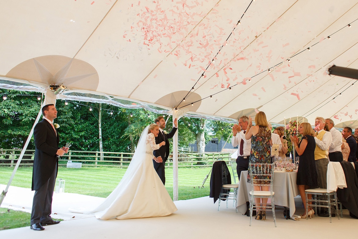 confetti cannons as the bride and groom enter the marquee