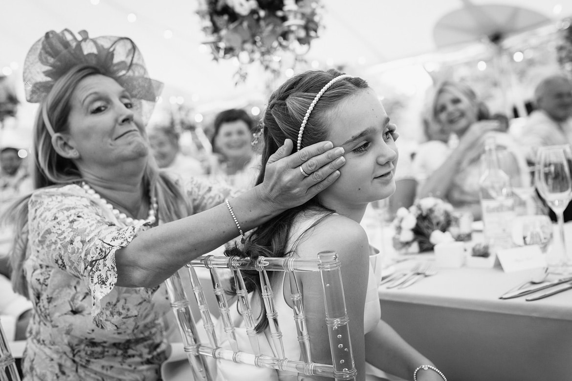 a guest covers her daughters ears during the speeches