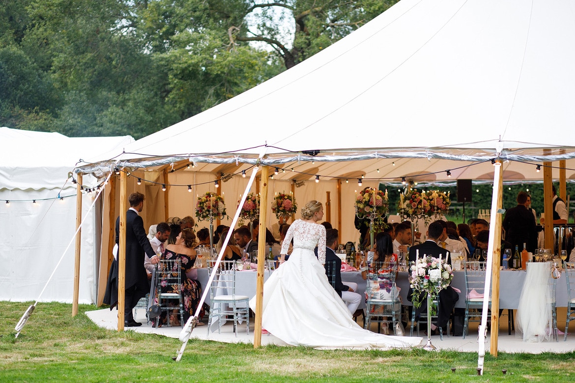 bride and groom talk to guests in the sperry tent