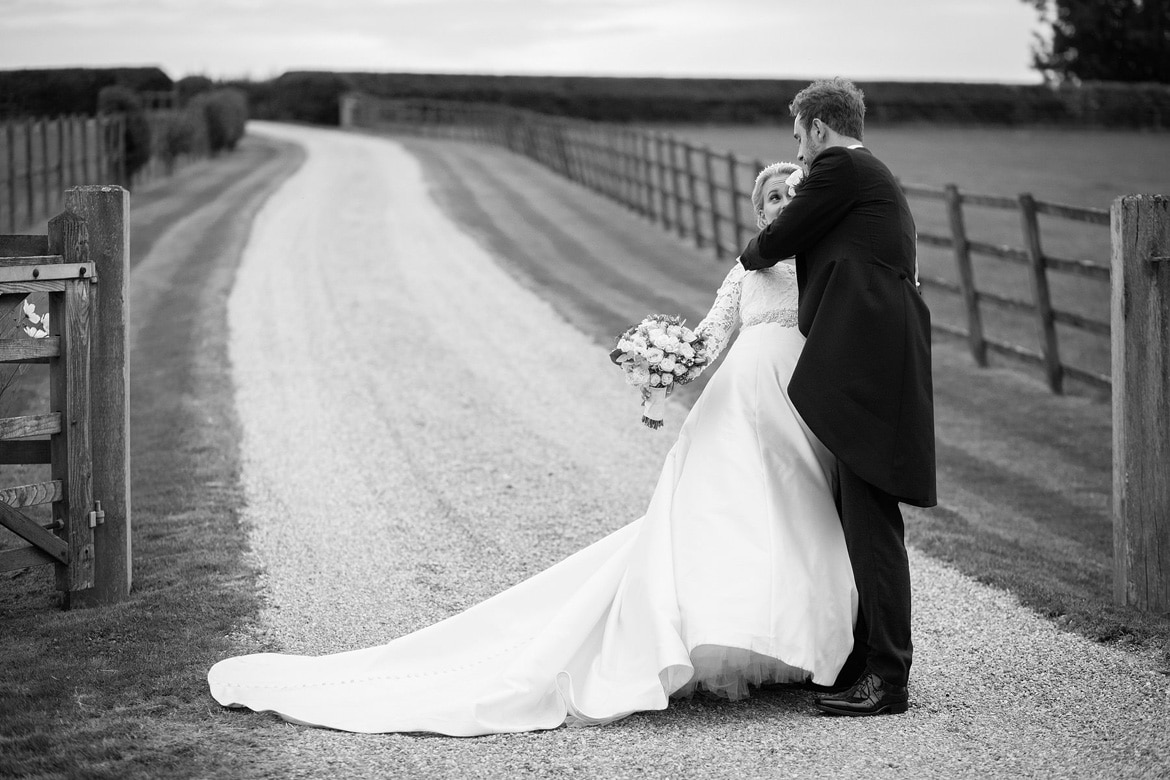 the groom tips the bride backwards