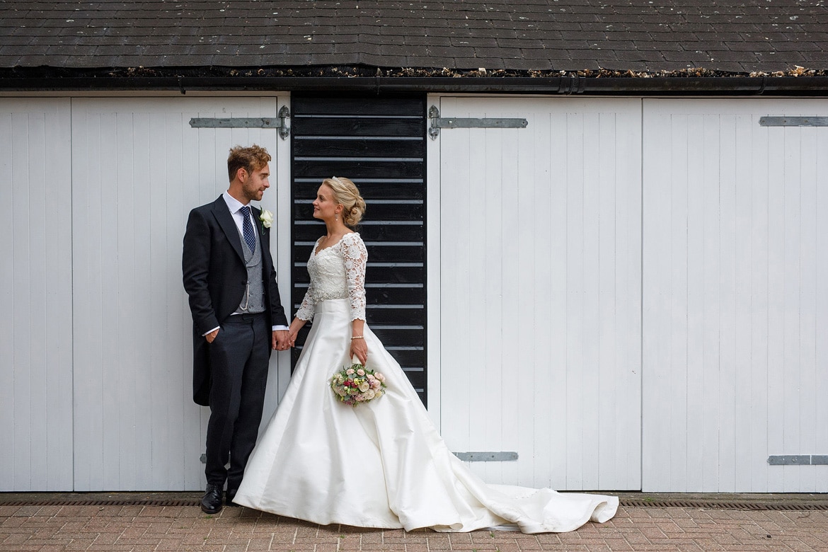 a couple portait in front of the stables