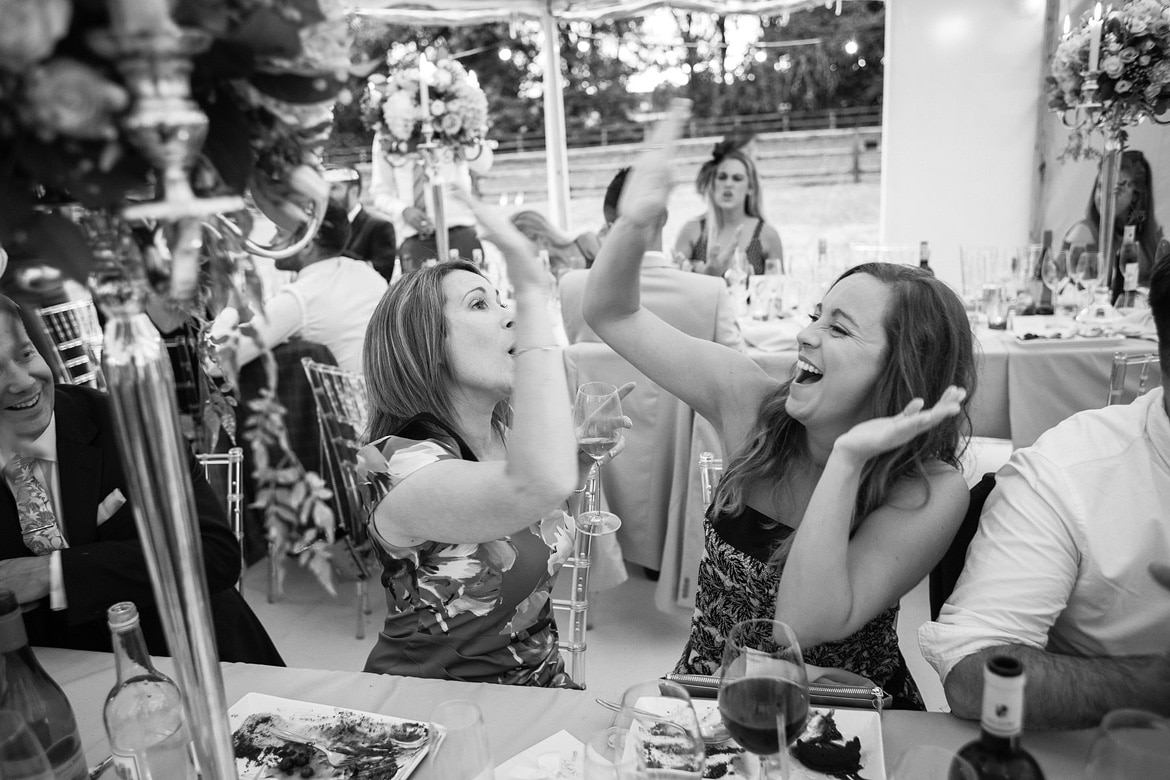 guests high five during the wedding breakfast