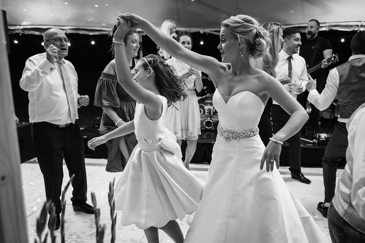 the bride dances with a flowergirl