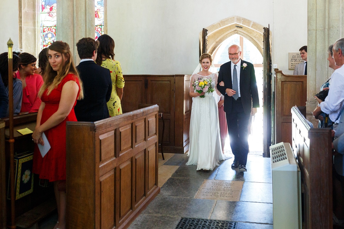 the bride and her father enter the church