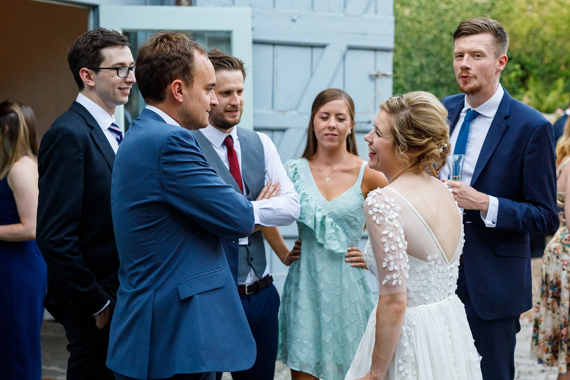 the bride laughs with her guests