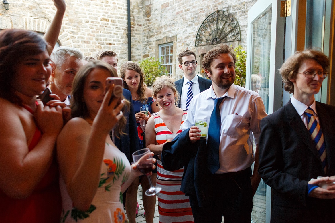 wedding guests watching the cake cutting