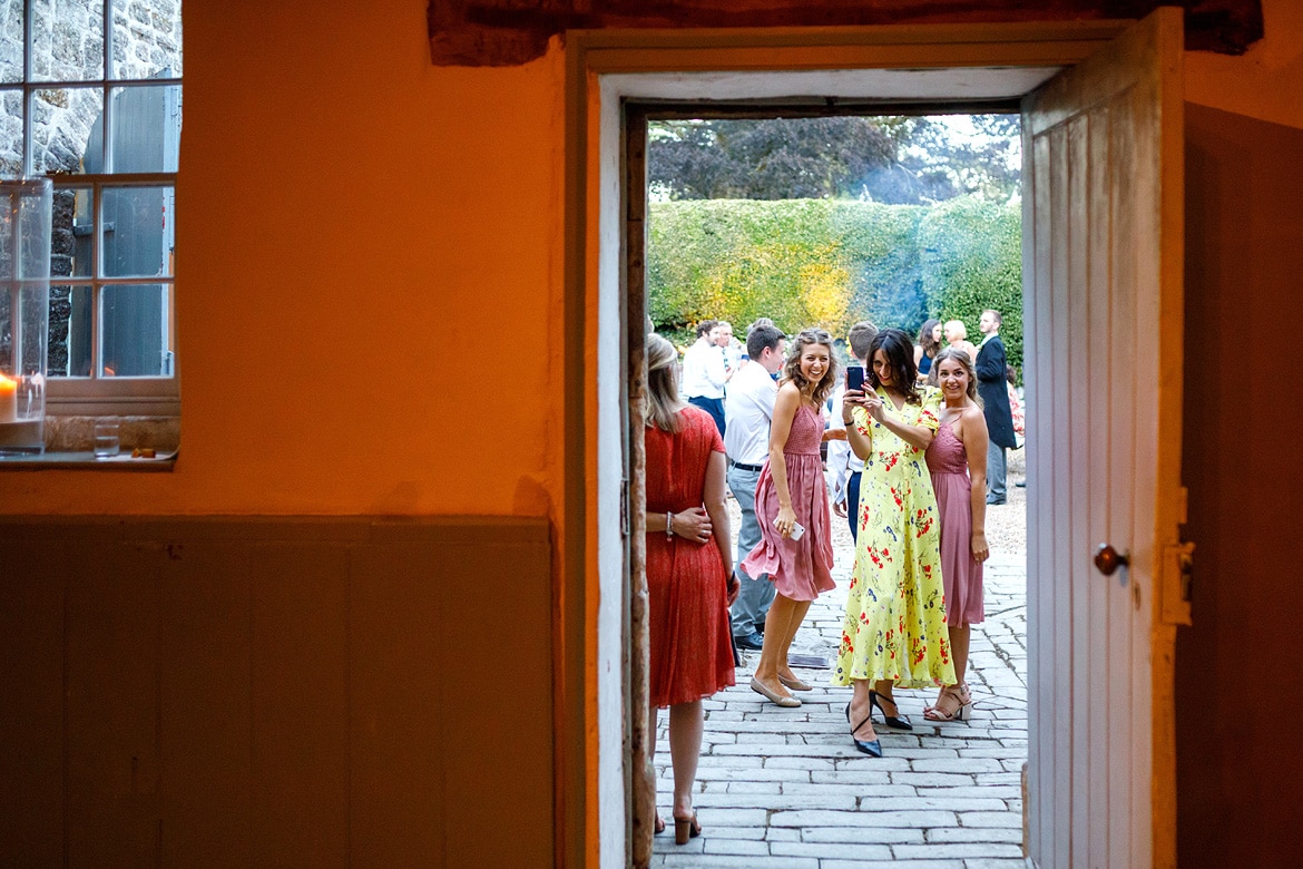 wedding guests enjoy the warm evening outside