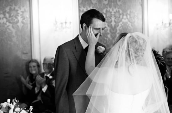 bryony wipes a tear from richards face during their somerleyton hall wedding ceremony