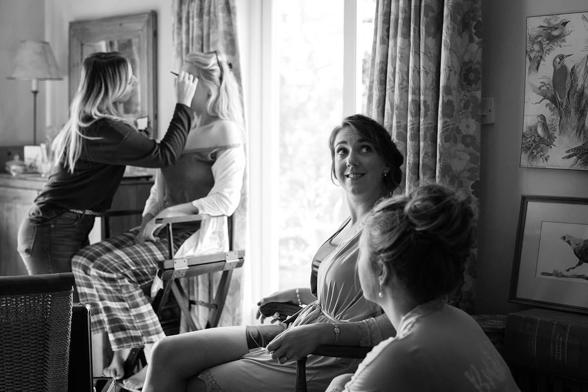 a bridesmaid smiles during the preps