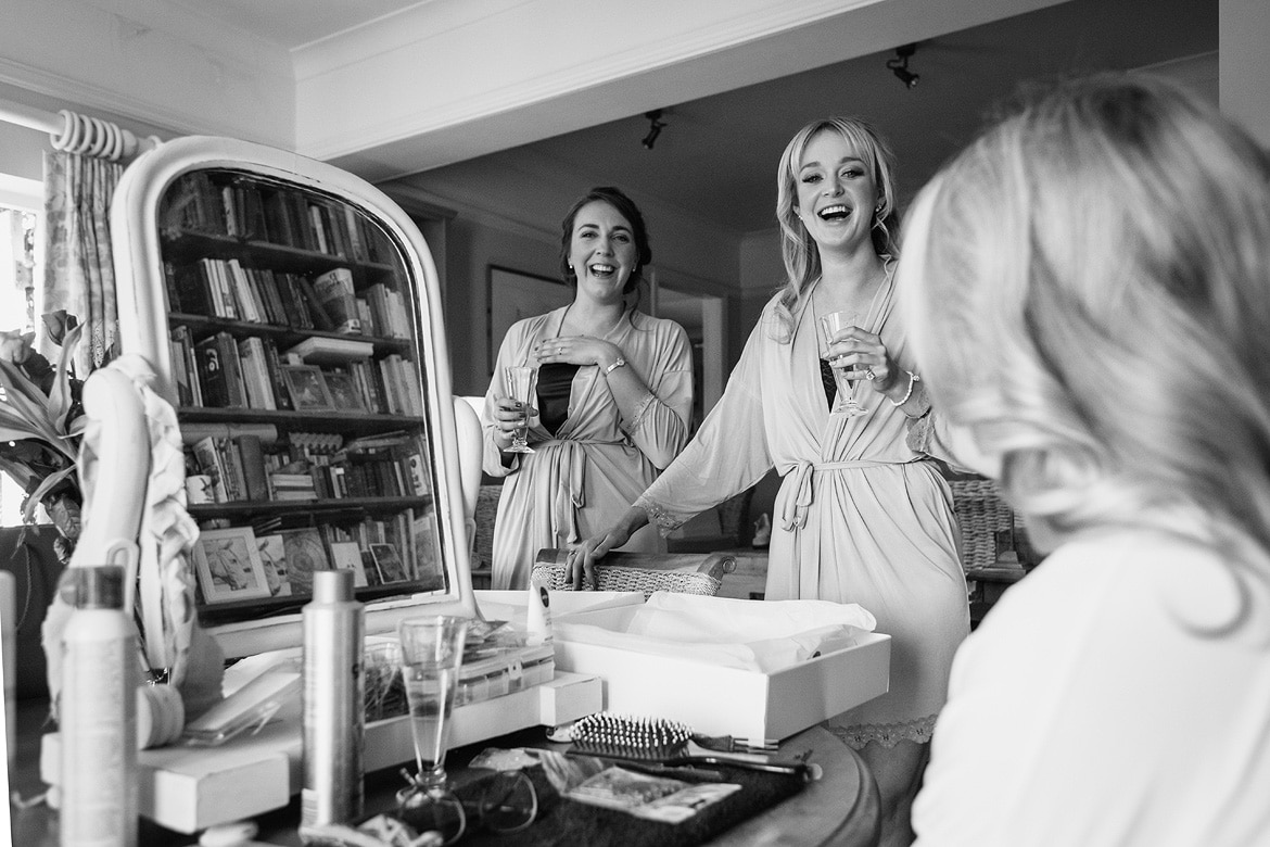 bridesmaids laughing with the bride