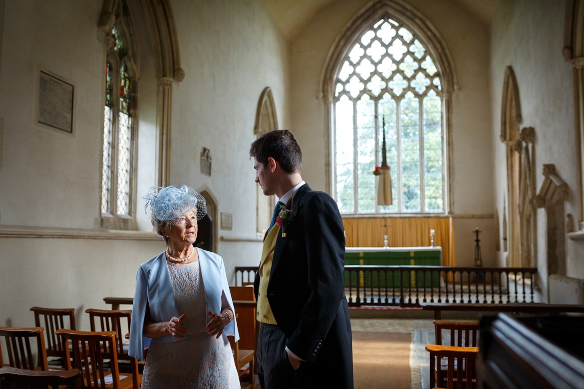 the groom and a wedding guest chat