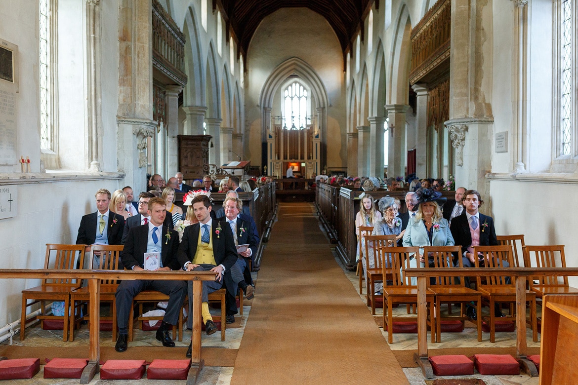 wedding guests waiting inside dennington church