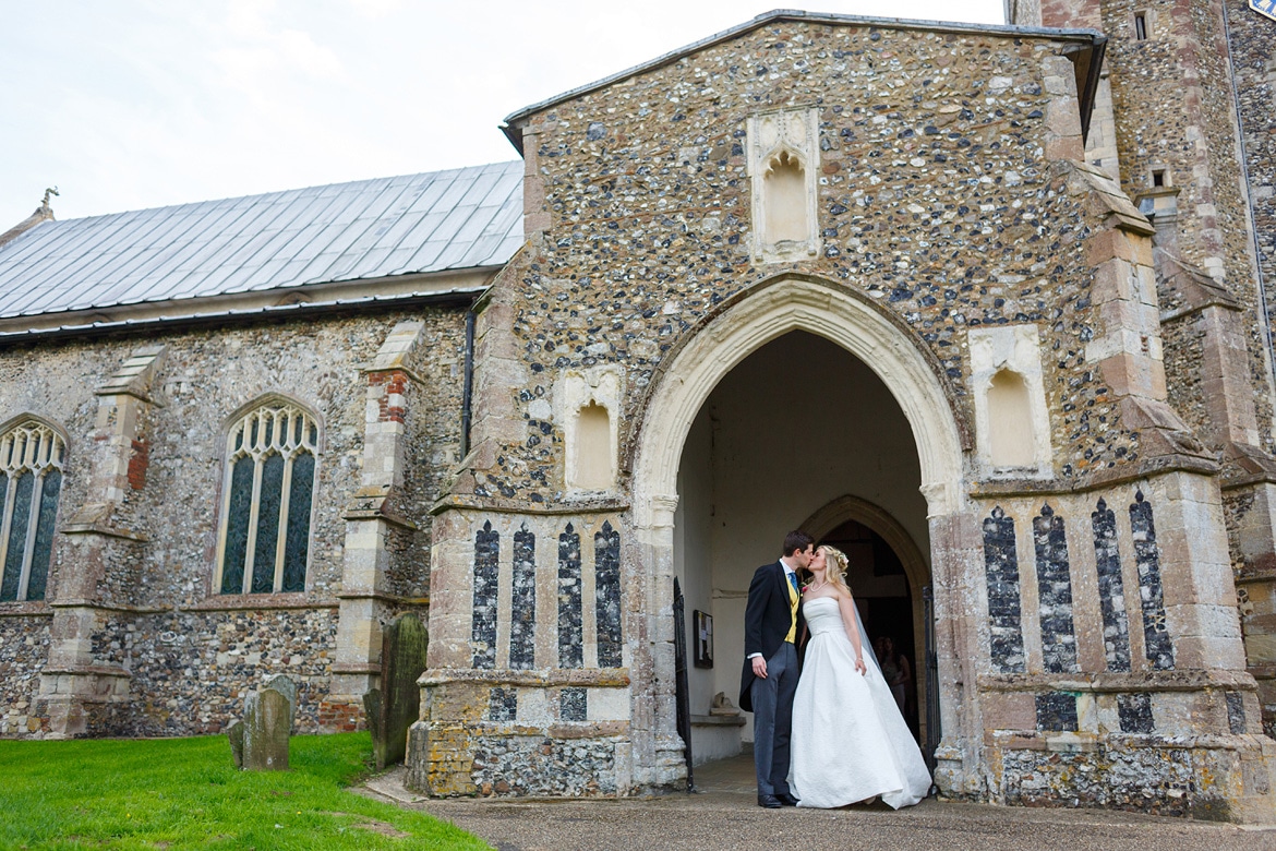 kissing in the doorway of dennington church