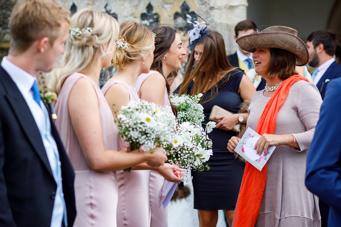 bridesmaids talk to wedding guests