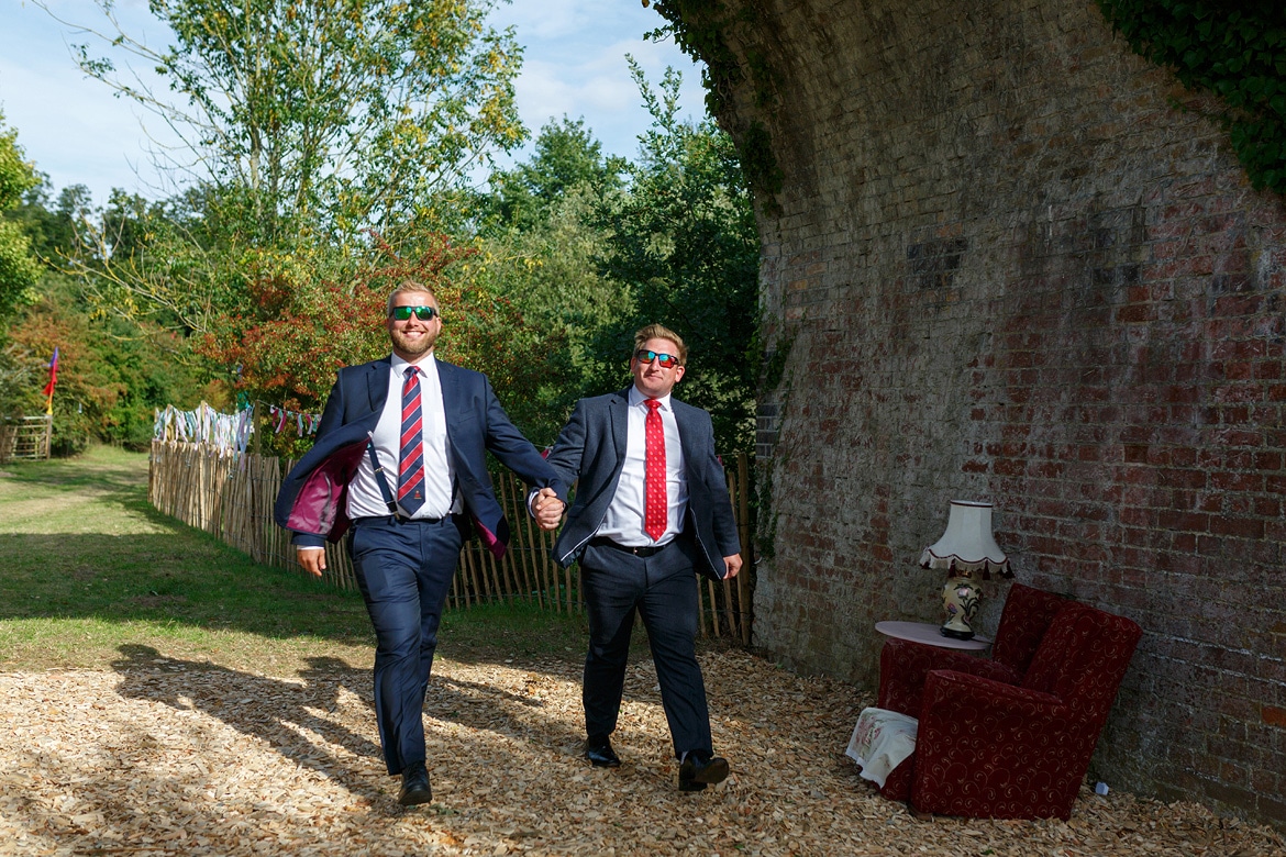 wedding guests arrive under the railway arch