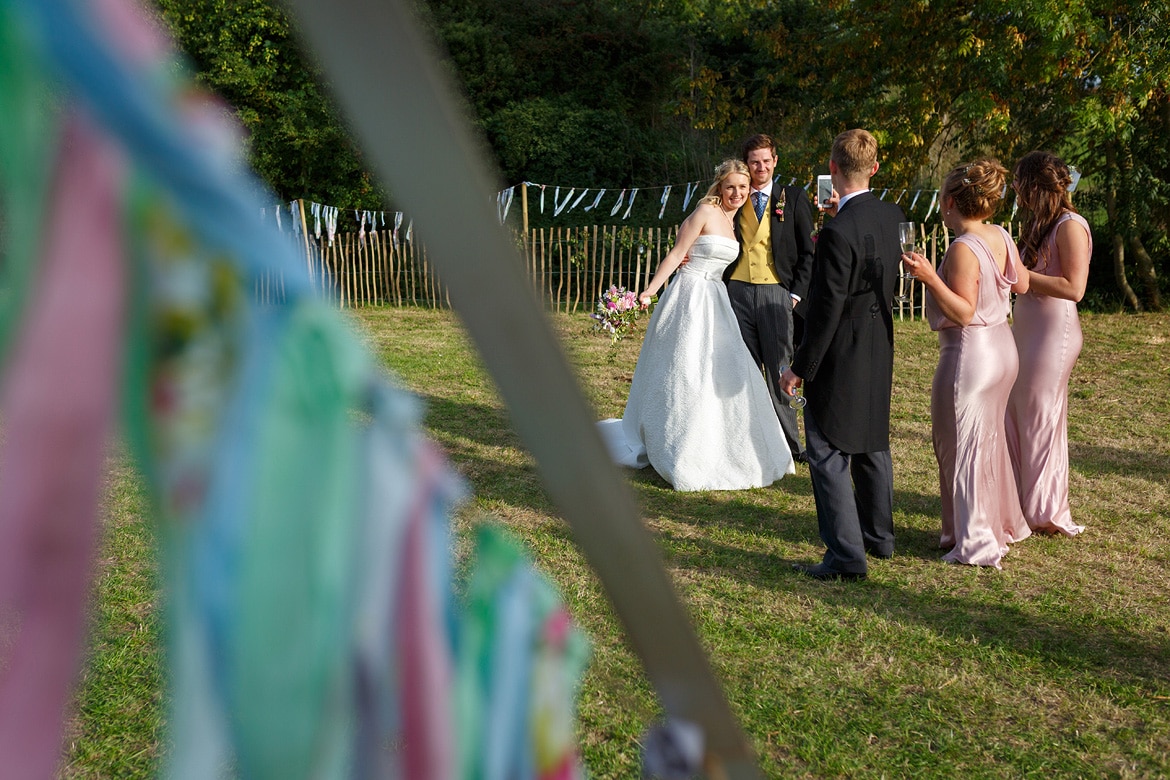 bride and groom pose for guests