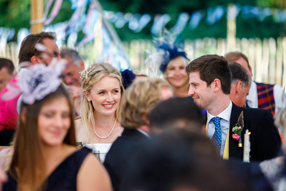 the bride smiles at her dads speech