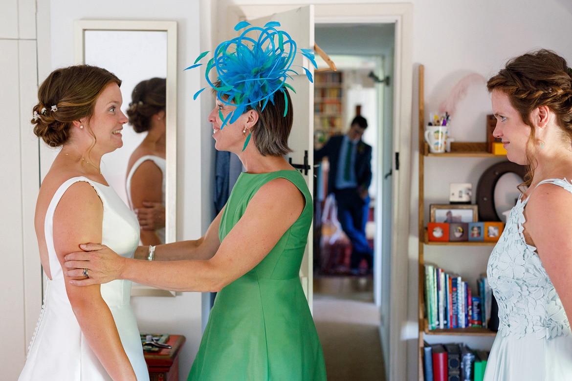 a nervous bride and her mum exchange looks